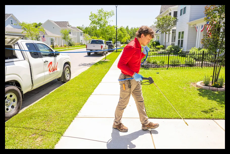 an employee in front of a house